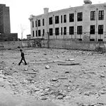 A boy walking through a vacant lot at 13th Street, 1981.<br/>
